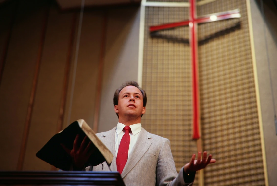 Man preaching with a Bible in church