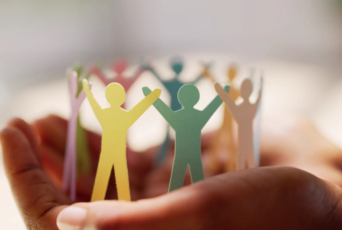 Paper figures in hands