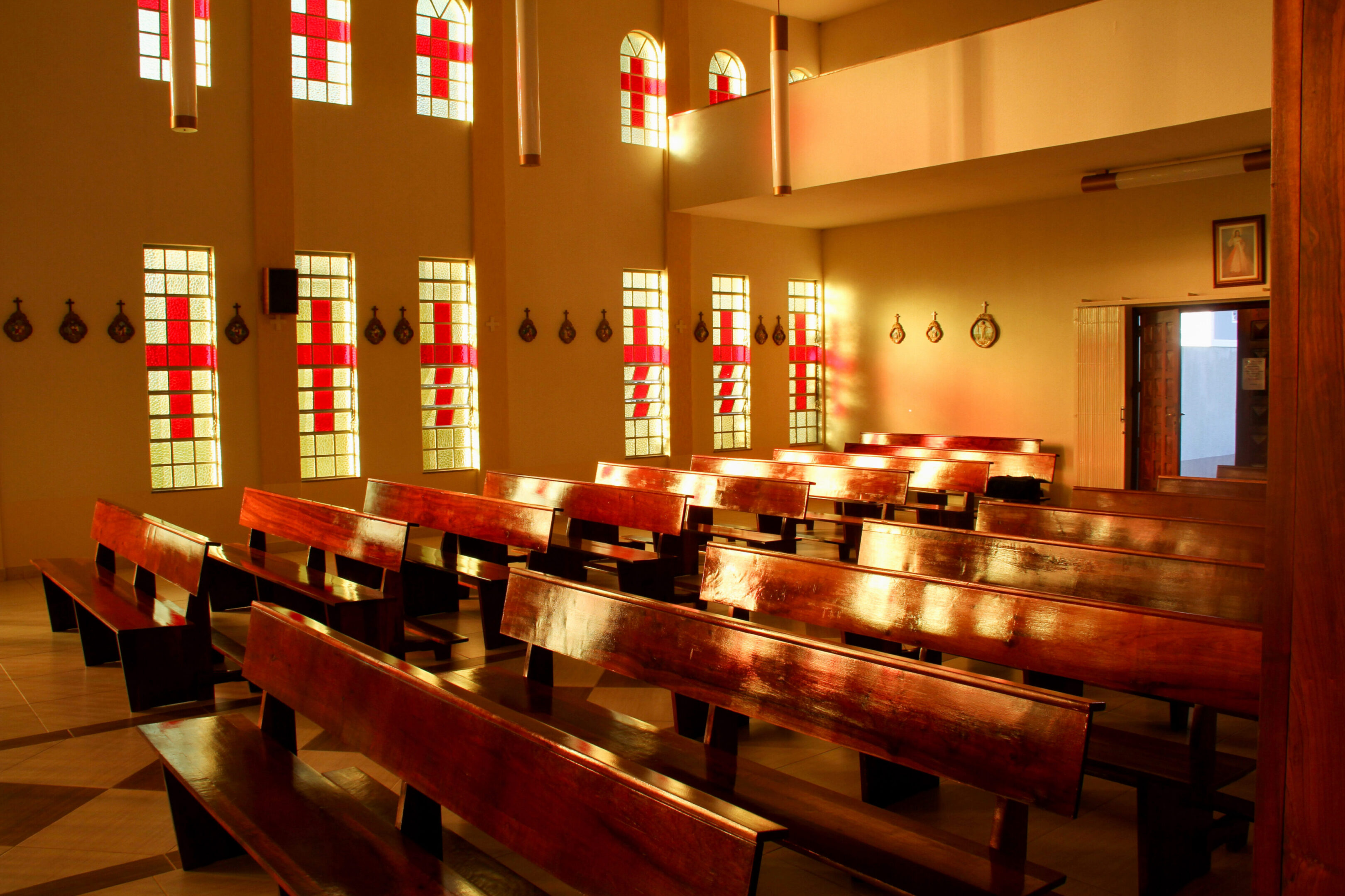 Sunlit church interior with wooden pews.
