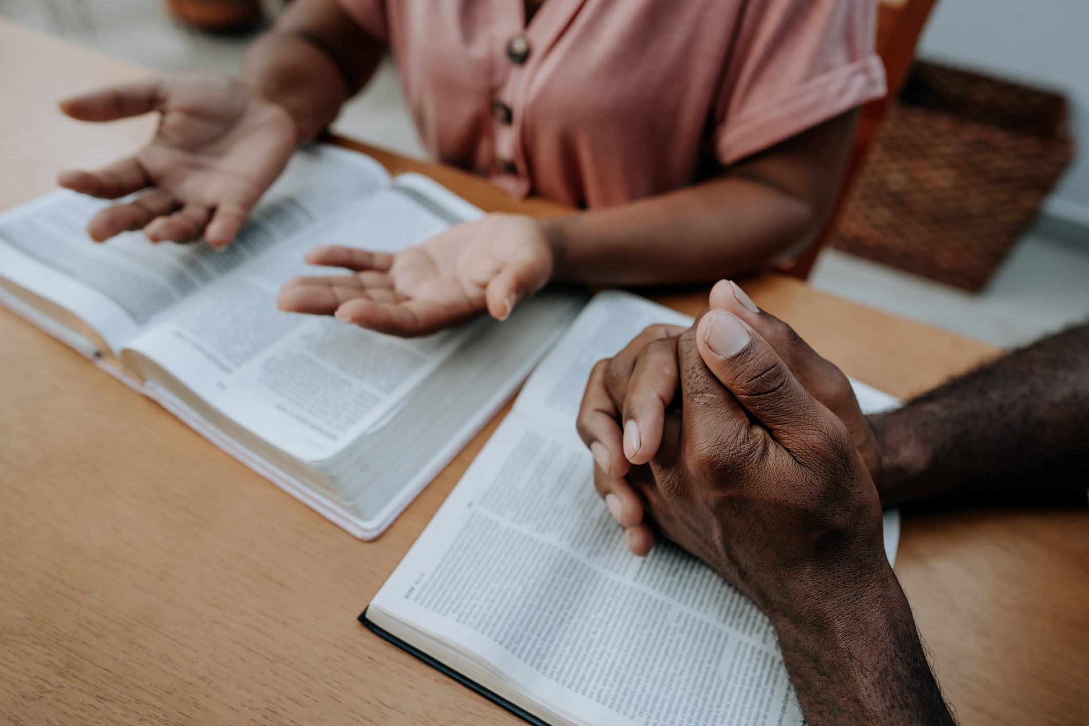 People reading and discussing open books together.