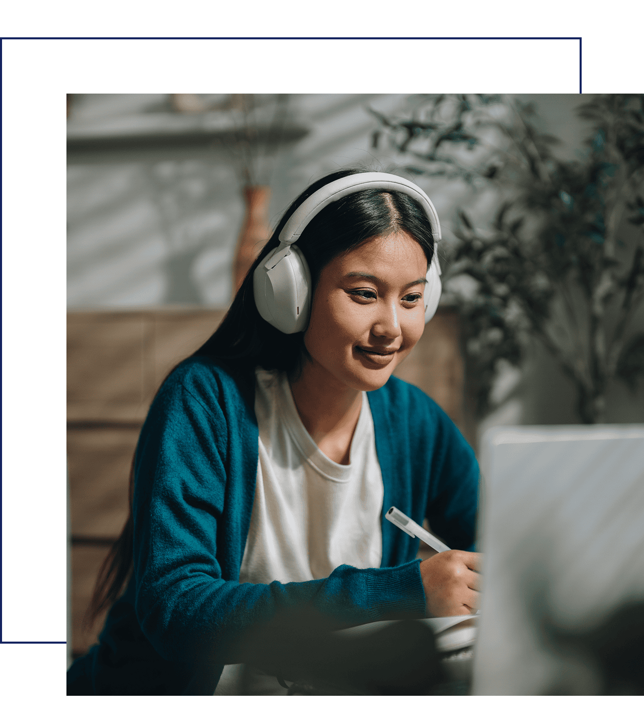 Woman with headphones studying on laptop.
