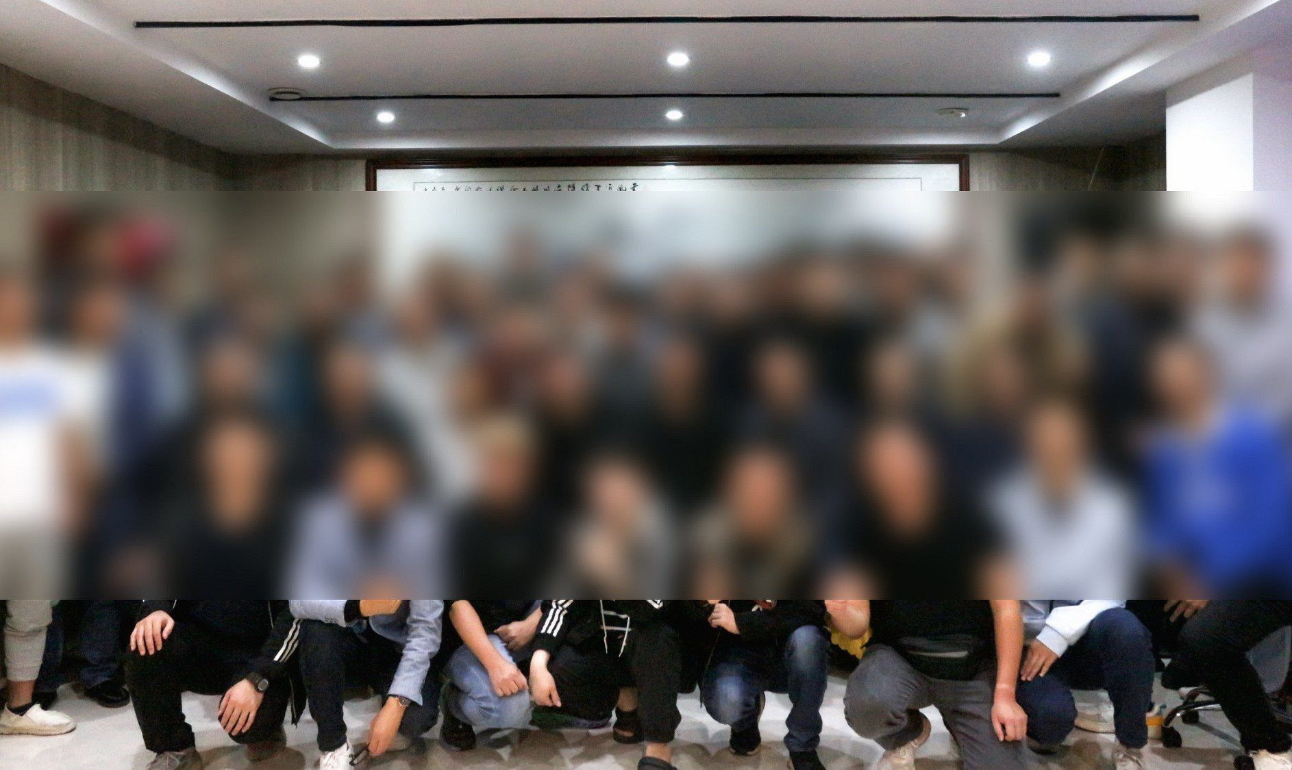 A large ministry gathering indoors, with faces blurred