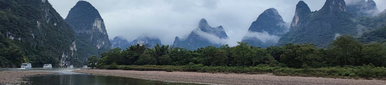 River and mist-covered mountains in China